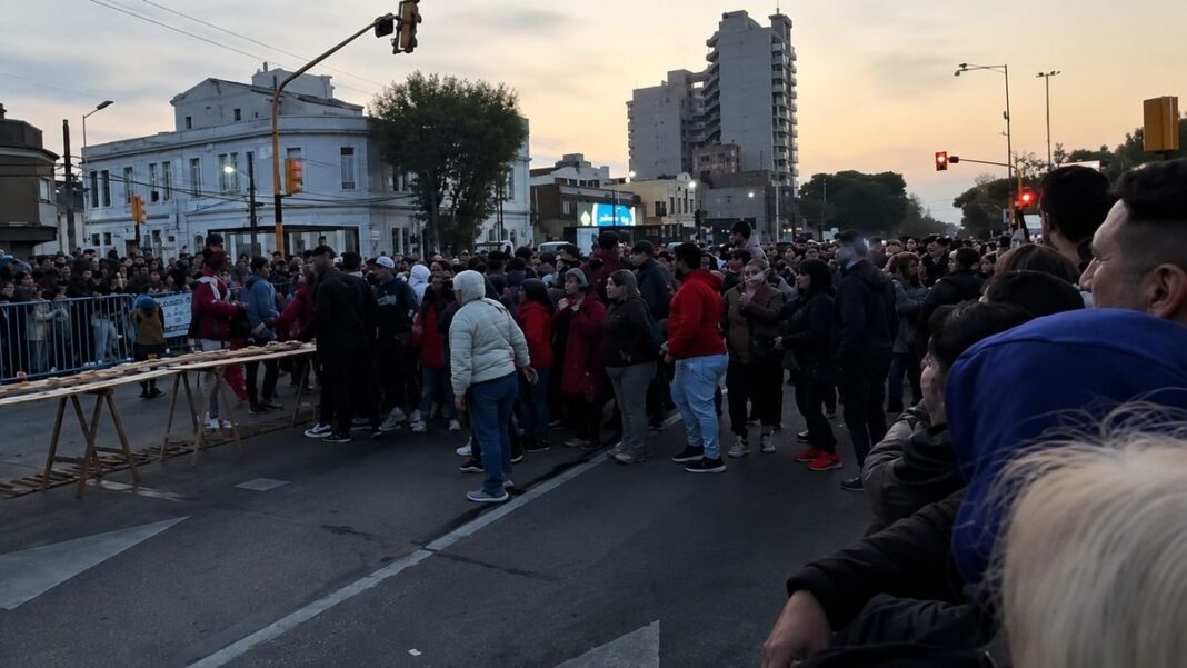 Personas alrededor de un sándwich gigante en la calle en Avellaneda