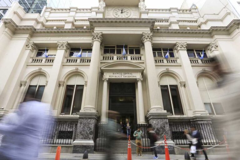 Personas frente a un banco cerrado con cartel de paro bancario